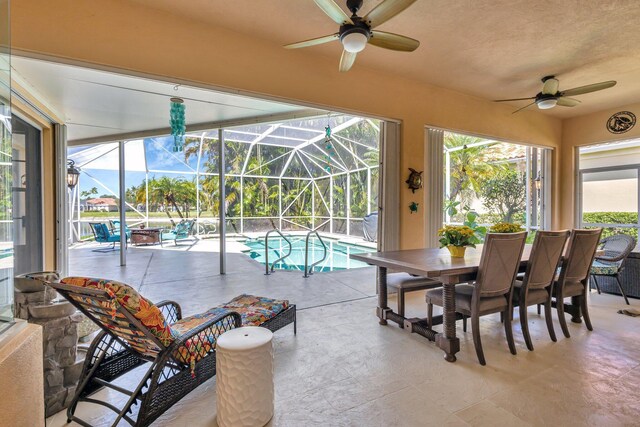 2211 Vero Beach Ln, West Palm Beach, FL 33411 - outdoor pool featuring a ceiling fan, outdoor dining area, a patio area, and a lanai