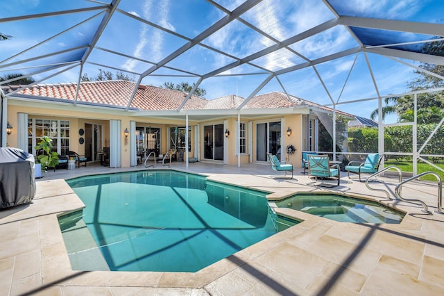 2211 Vero Beach Ln, West Palm Beach, FL 33411 - view of swimming pool with a patio area, a lanai, and a pool with connected hot tub