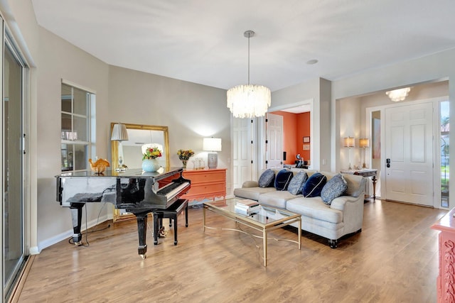 2211 Vero Beach Ln, West Palm Beach, FL 33411 - living room featuring a chandelier, wood finished floors, and baseboards