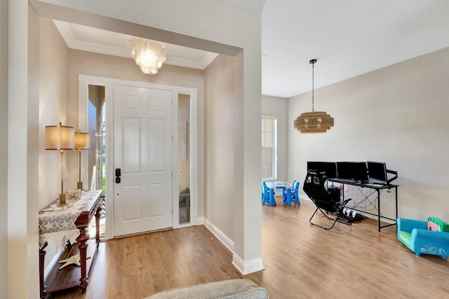 2211 Vero Beach Ln, West Palm Beach, FL 33411 - foyer featuring wood finished floors, a chandelier, baseboards, crown molding, and plenty of natural light