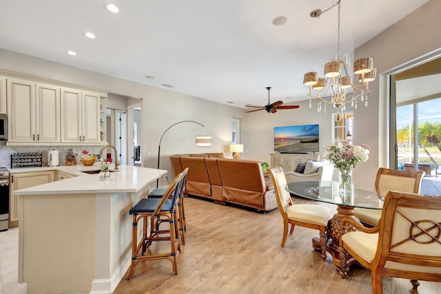 2211 Vero Beach Ln, West Palm Beach, FL 33411 - kitchen featuring a sink, a ceiling fan, tasteful backsplash, light wood finished floors, and recessed lighting