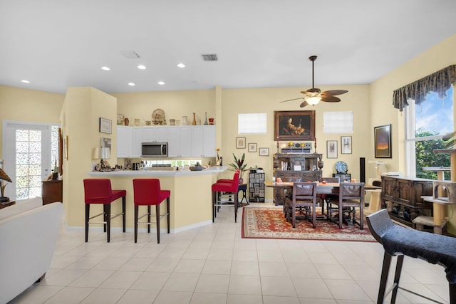 dining space with a ceiling fan and recessed lighting