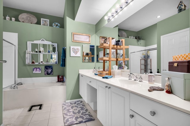 bathroom with a shower stall, tile patterned floors, a bath, and vanity