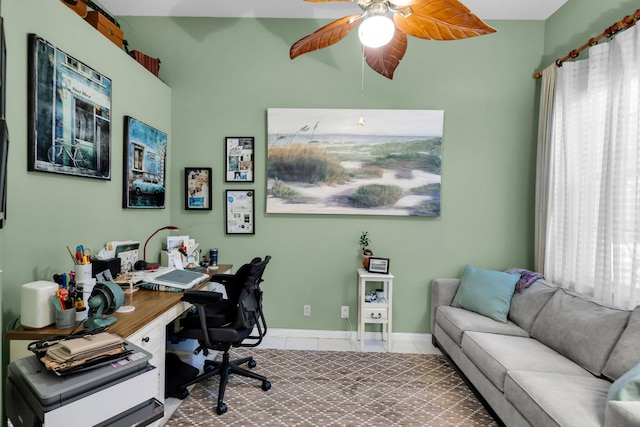 office space with a ceiling fan, tile patterned flooring, and baseboards