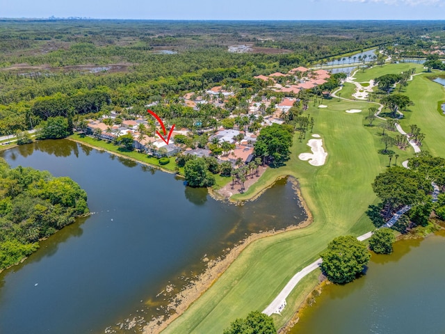 aerial overview of property's location with a golf course, a large body of water, and nearby suburban area
