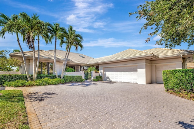 6022 SE Oakmont Pl, Stuart, FL 34997 - ranch-style home featuring an attached garage, driveway, stucco siding, and a tiled roof