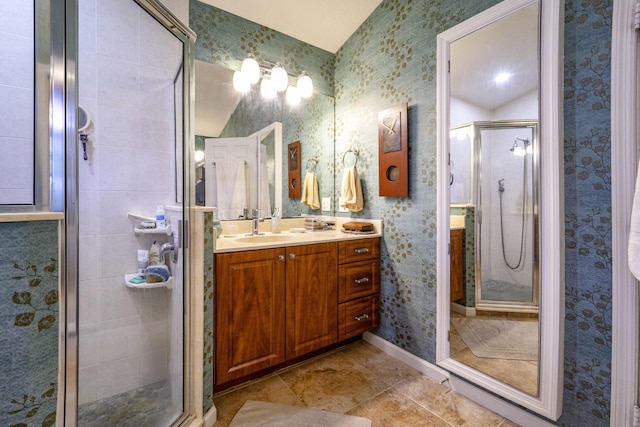 full bath with a stall shower, vanity, wallpapered walls, tile patterned floors, and baseboards