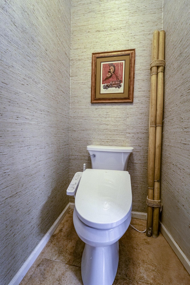 bathroom featuring baseboards and toilet