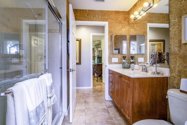 full bathroom featuring toilet, a shower stall, vanity, and tile patterned floors