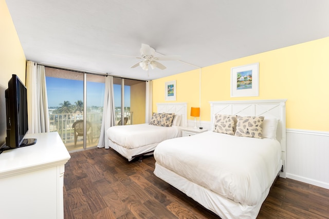 9800 S Ocean Dr Unit 415, Jensen Beach, FL 34957 - bedroom with dark wood finished floors, access to outside, a wainscoted wall, and a ceiling fan