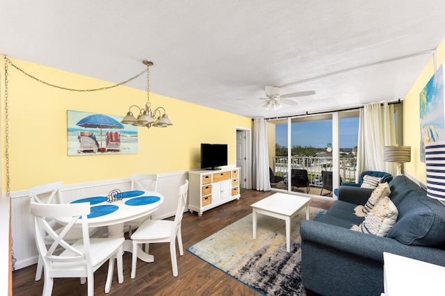 9800 S Ocean Dr Unit 415, Jensen Beach, FL 34957 - living area with a ceiling fan, a chandelier, dark wood-style floors, and a wainscoted wall