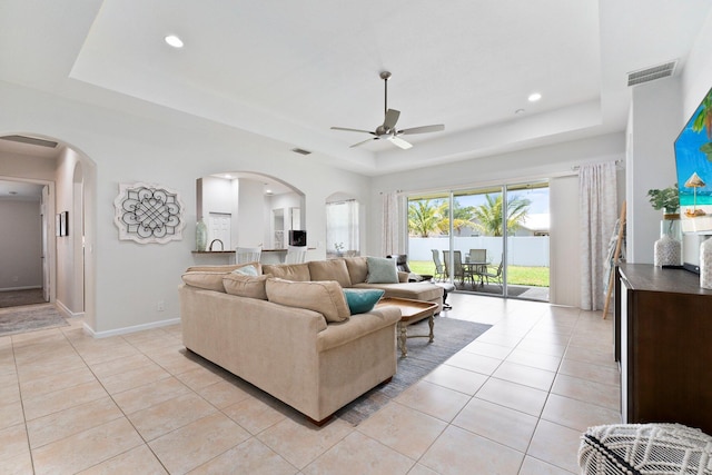 3552 SW Dellamano St, Port Saint Lucie, FL 34953 - living area with a raised ceiling, ceiling fan, arched walkways, light tile patterned floors, and recessed lighting