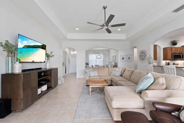 3552 SW Dellamano St, Port Saint Lucie, FL 34953 - living room featuring arched walkways, ceiling fan, light tile patterned floors, a raised ceiling, and recessed lighting