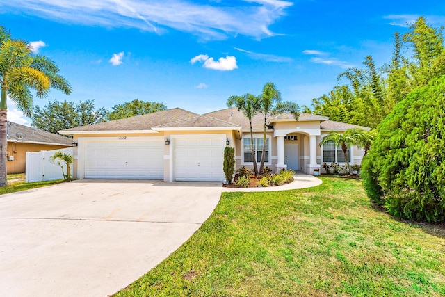 3552 SW Dellamano St, Port Saint Lucie, FL 34953 - ranch-style home with stucco siding, an attached garage, and driveway