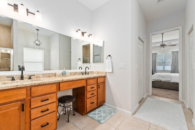 3552 SW Dellamano St, Port Saint Lucie, FL 34953 - ensuite bathroom with double vanity, tile patterned flooring, an enclosed shower, a ceiling fan, and baseboards