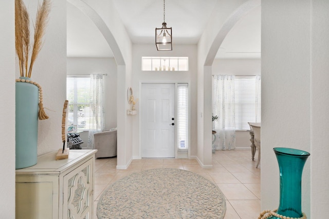 3552 SW Dellamano St, Port Saint Lucie, FL 34953 - foyer with light tile patterned floors, arched walkways, and baseboards