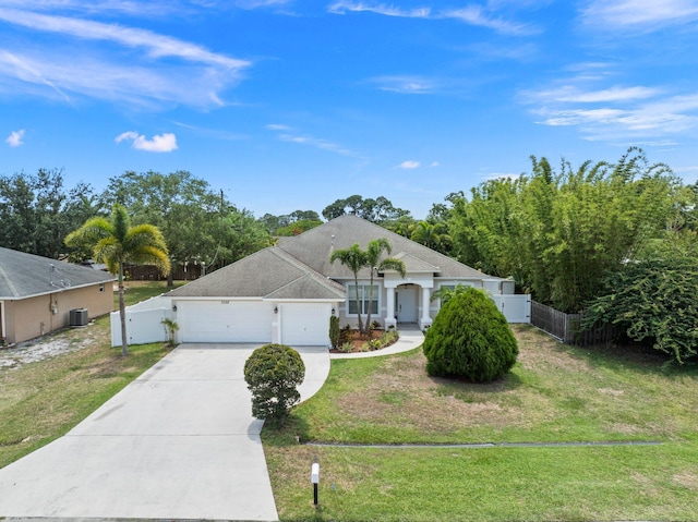 3552 SW Dellamano St, Port Saint Lucie, FL 34953 - view of front of property featuring concrete driveway, a garage, a gate, and central AC unit