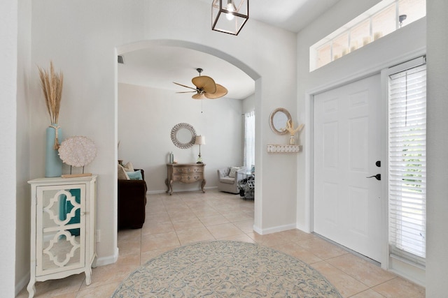 3552 SW Dellamano St, Port Saint Lucie, FL 34953 - entrance foyer with arched walkways, plenty of natural light, light tile patterned flooring, and a ceiling fan