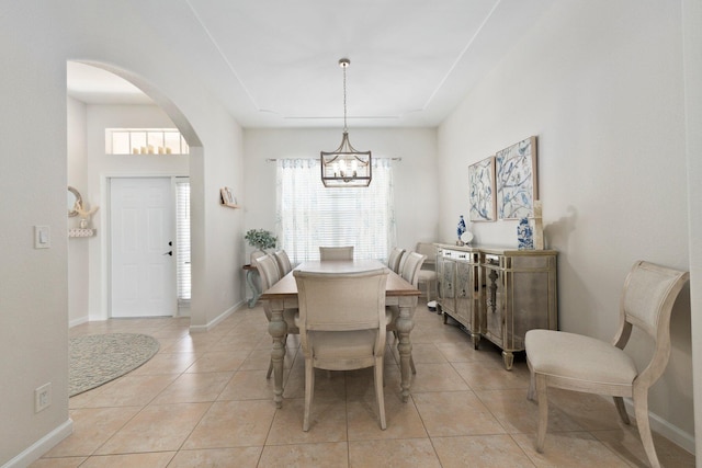 3552 SW Dellamano St, Port Saint Lucie, FL 34953 - dining room featuring arched walkways, a chandelier, healthy amount of natural light, and light tile patterned floors