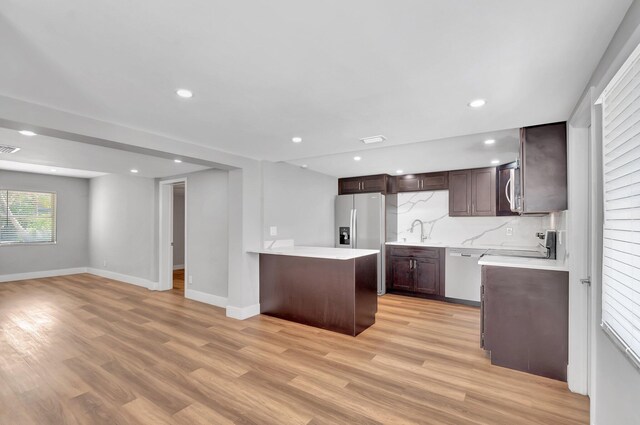125 E Hart St, Lantana, FL 33462 - kitchen with dark brown cabinets, light wood finished floors, light countertops, a sink, and recessed lighting