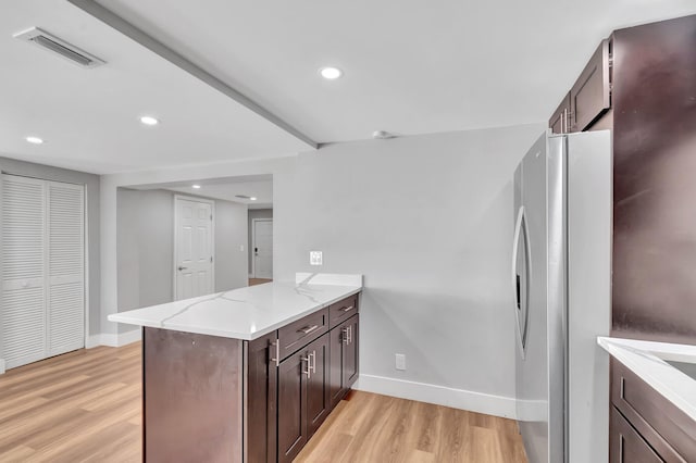 125 E Hart St, Lantana, FL 33462 - kitchen featuring freestanding refrigerator, light wood-style flooring, baseboards, a peninsula, and light stone counters
