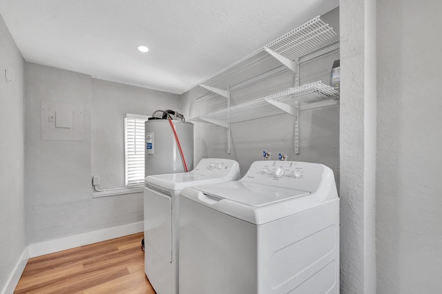 125 E Hart St, Lantana, FL 33462 - washroom with water heater, washing machine and dryer, baseboards, and wood finished floors