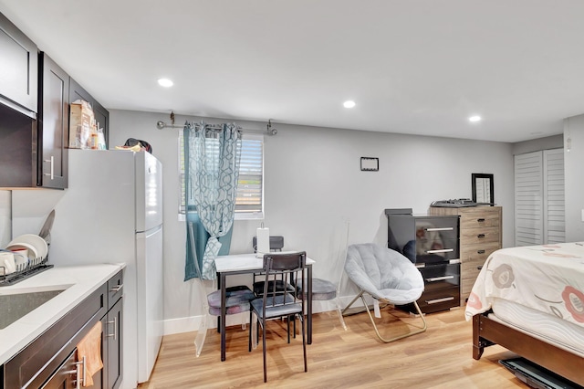125 E Hart St, Lantana, FL 33462 - bedroom featuring light wood-style floors, recessed lighting, freestanding refrigerator, a sink, and baseboards