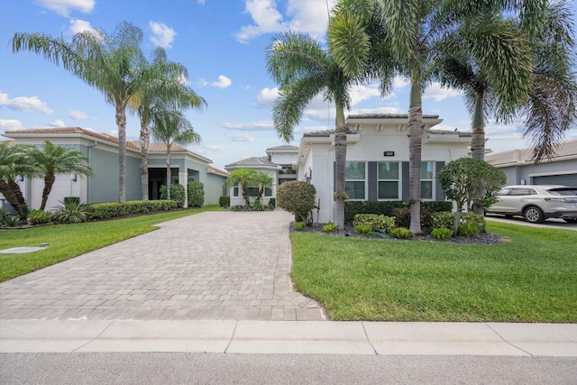 12582 Copper Mountain Pass, Boynton Beach, FL 33473 - mediterranean / spanish house featuring decorative driveway, a front lawn, and stucco siding