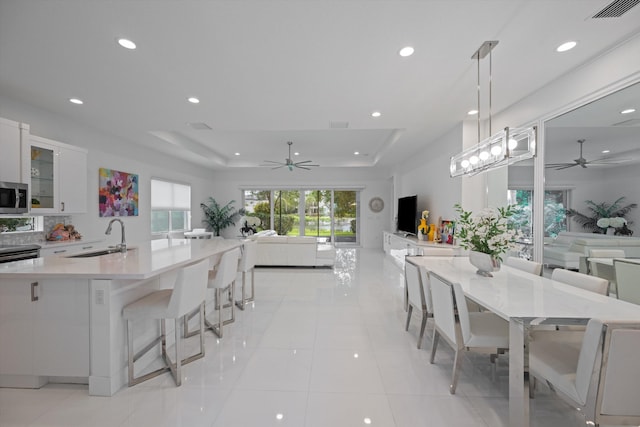 12582 Copper Mountain Pass, Boynton Beach, FL 33473 - kitchen with ceiling fan, open floor plan, stainless steel microwave, recessed lighting, and white cabinets