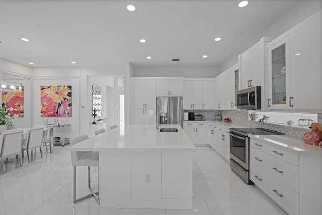 12582 Copper Mountain Pass, Boynton Beach, FL 33473 - kitchen featuring stainless steel appliances, a sink, light countertops, white cabinetry, and recessed lighting
