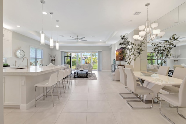 12685 New Caladonia Ln, Boynton Beach, FL 33473 - dining space with a tray ceiling, ceiling fan, recessed lighting, and light tile patterned floors