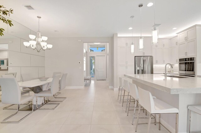 12685 New Caladonia Ln, Boynton Beach, FL 33473 - dining area with a chandelier, baseboards, light tile patterned floors, and recessed lighting