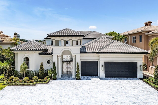 17709 Circle Pond Ct, Boca Raton, FL 33496 - mediterranean / spanish-style home with a garage, a tile roof, stucco siding, and decorative driveway