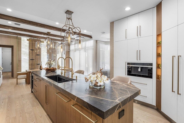 17709 Circle Pond Ct, Boca Raton, FL 33496 - kitchen featuring a sink, light wood finished floors, dark countertops, modern cabinets, and recessed lighting
