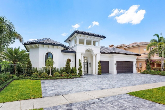 17709 Circle Pond Ct, Boca Raton, FL 33496 - mediterranean / spanish-style house with a garage, decorative driveway, a tiled roof, and stucco siding
