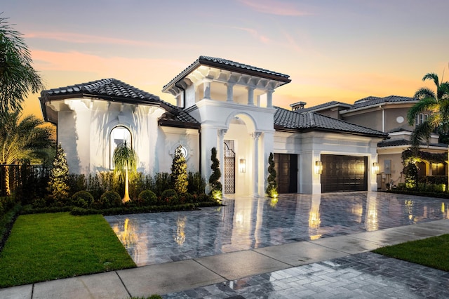 17709 Circle Pond Ct, Boca Raton, FL 33496 - mediterranean / spanish home with a tile roof, an attached garage, decorative driveway, and stucco siding