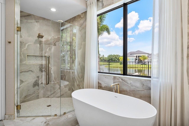 17709 Circle Pond Ct, Boca Raton, FL 33496 - full bath featuring tile walls, a freestanding tub, a marble finish shower, a water view, and marble finish flooring