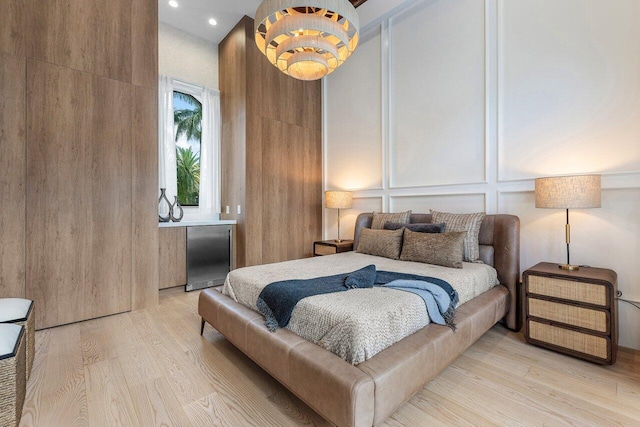 17709 Circle Pond Ct, Boca Raton, FL 33496 - bedroom with stainless steel refrigerator, light wood finished floors, a decorative wall, and recessed lighting