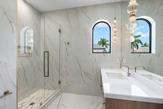 17709 Circle Pond Ct, Boca Raton, FL 33496 - full bath featuring a marble finish shower, vanity, tile walls, and plenty of natural light