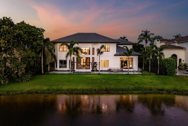 17709 Circle Pond Ct, Boca Raton, FL 33496 - back of house featuring a water view, stucco siding, a tiled roof, and a patio area