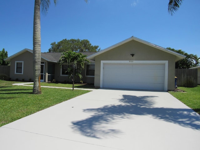 648 NE Maranta Terrado, Jensen Beach, FL 34957 - ranch-style home with stucco siding, driveway, and an attached garage