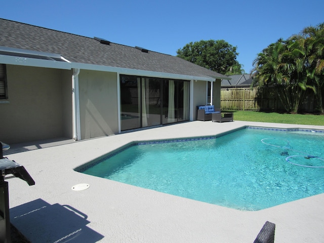 648 NE Maranta Terrado, Jensen Beach, FL 34957 - view of swimming pool featuring fence and a patio