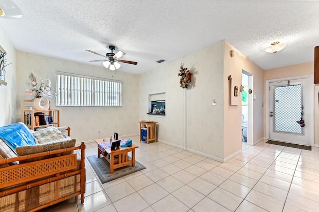 109 Lake Rebecca Dr Unit 109, West Palm Beach, FL 33411 - living area featuring a ceiling fan, healthy amount of natural light, a textured ceiling, and light tile patterned floors