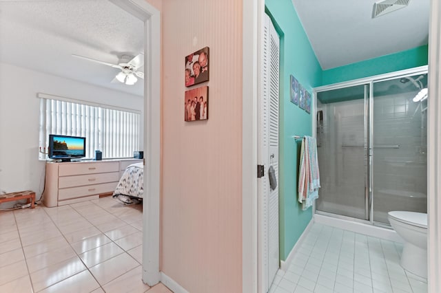 109 Lake Rebecca Dr Unit 109, West Palm Beach, FL 33411 - full bathroom featuring tile patterned floors, a shower stall, ceiling fan, and a closet