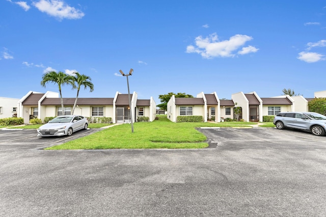 109 Lake Rebecca Dr Unit 109, West Palm Beach, FL 33411 - multi unit property with uncovered parking, stucco siding, and a front lawn
