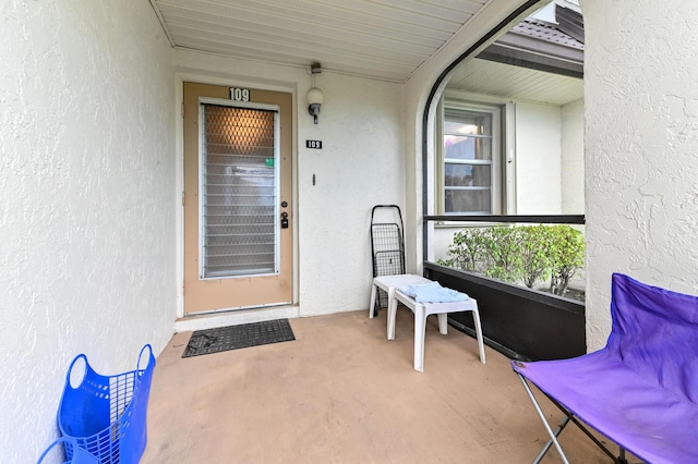 109 Lake Rebecca Dr Unit 109, West Palm Beach, FL 33411 - view of exterior entry featuring stucco siding and a porch