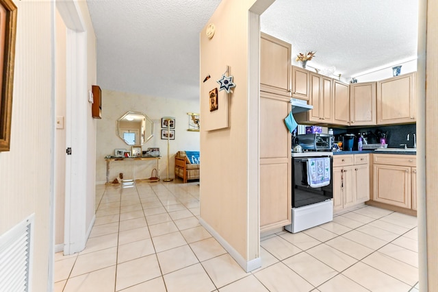 109 Lake Rebecca Dr Unit 109, West Palm Beach, FL 33411 - kitchen with electric range, a textured ceiling, light brown cabinets, light tile patterned floors, and under cabinet range hood