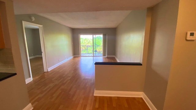 490 NW 20th St Unit 314, Boca Raton, FL 33431 - empty room featuring wood finished floors, baseboards, and a smoke detector