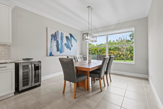 8369 Paladin Sq, Vero Beach, FL 32967 - dining space with wine cooler, ornamental molding, a chandelier, light tile patterned floors, and baseboards
