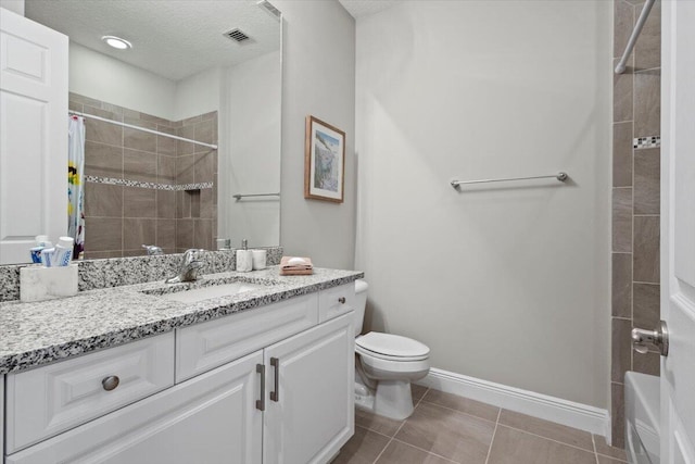 8369 Paladin Sq, Vero Beach, FL 32967 - bathroom with toilet, tile patterned floors, vanity, a textured ceiling, and baseboards